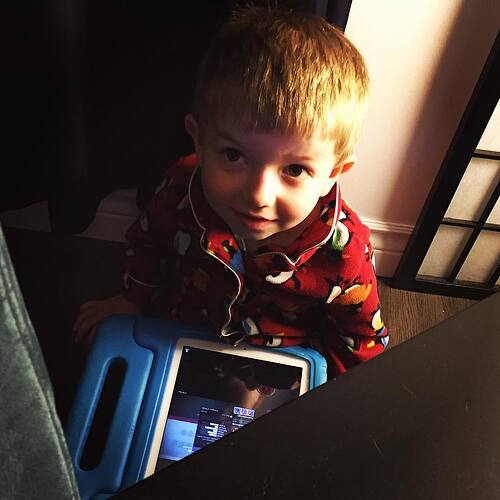 Hiding from Mom with his new iPad.