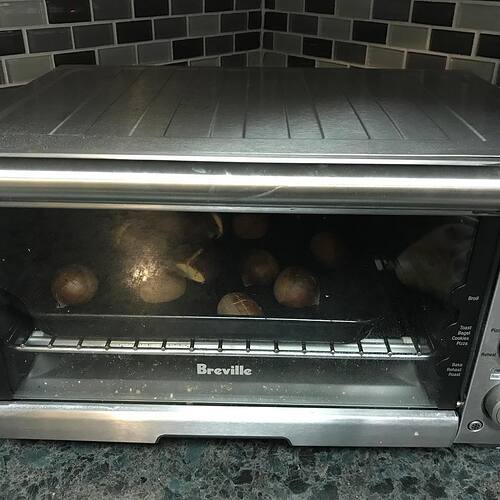 Chestnuts roasting in a toaster oven.