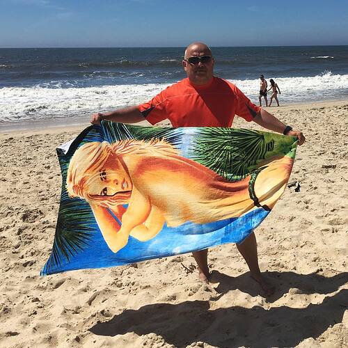 This is my Father’s Day gift. Carmen calls this my “topless Taylor Swift towel.” When I get sand on it, I have to … shake it off.
