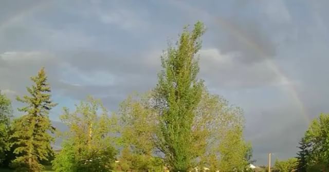 My weathercam caught a rainbow, followed by a purple sky.